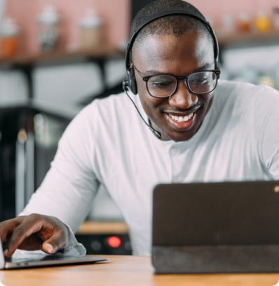 Man working on an ipad and smiling.